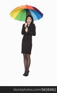 Businesswoman under colorful umbrella