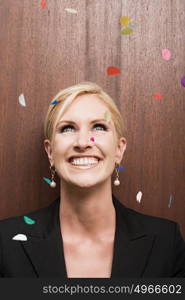 Businesswoman under falling confetti