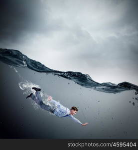 Businesswoman under water. Young businessman in suit swimming in crystal blue water