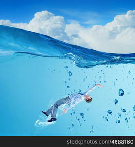 Businesswoman under water. Young businessman in suit swimming in crystal blue water