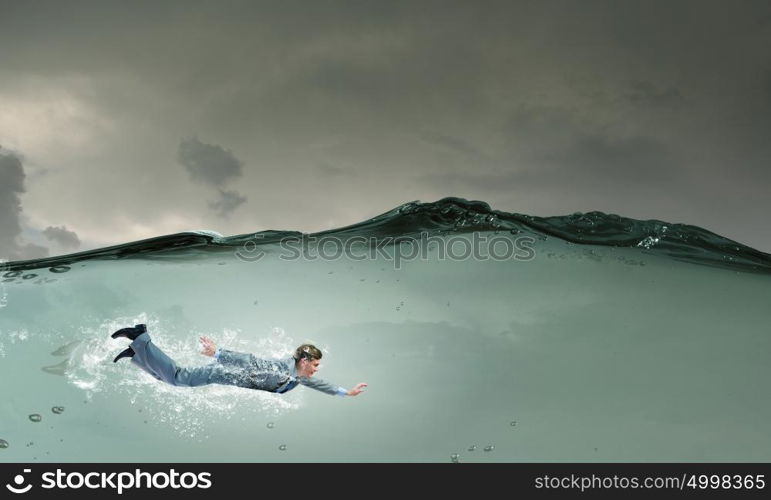 Businesswoman under water. Young businessman in suit swimming in crystal blue water