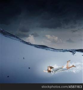 Businesswoman under water. Young businesswoman in suit swimming in stormy waters