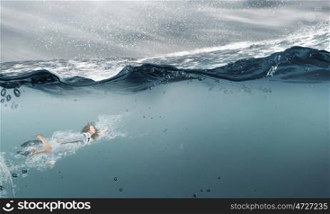 Businesswoman under water. Young businesswoman in suit swimming in stormy waters
