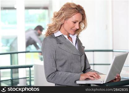 Businesswoman using a laptop computer in an office