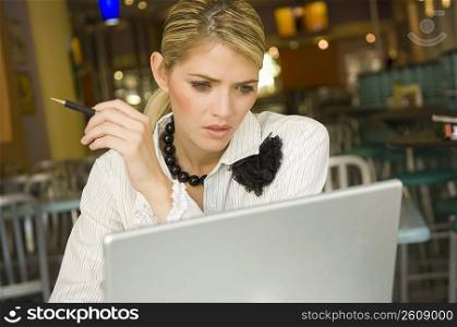 Businesswoman using a laptop in a restaurant