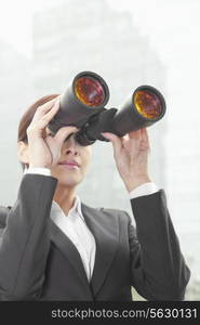 Businesswoman Using Binoculars Outside in Beijing