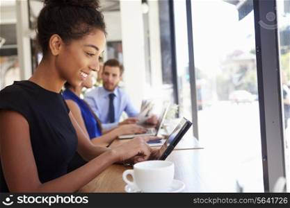 Businesswoman Using Digital Tablet In Coffee Shop