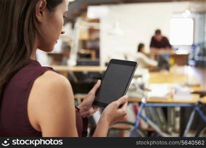 Businesswoman Using Digital Tablet In Modern Office