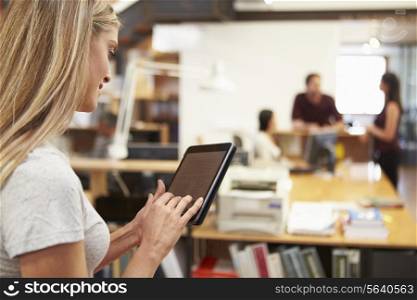 Businesswoman Using Digital Tablet In Modern Office