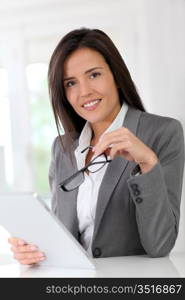 Businesswoman using electronic tablet at work