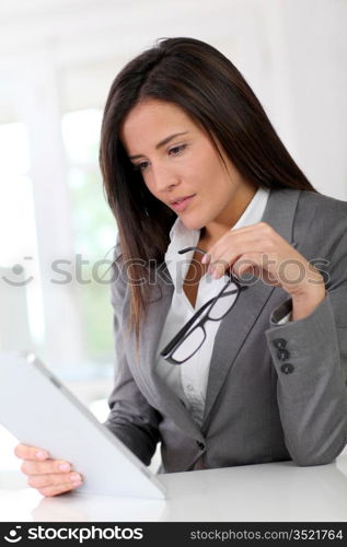 Businesswoman using electronic tablet at work