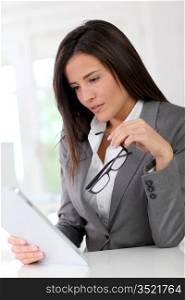 Businesswoman using electronic tablet at work