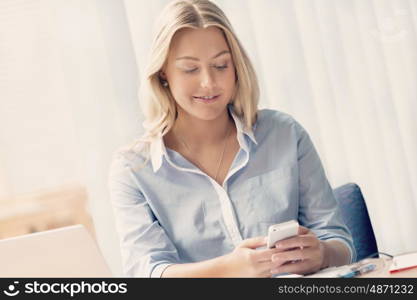 Businesswoman using her mobile in offfice