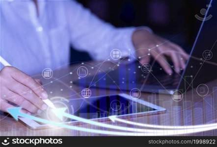 Businesswoman using laptop analyzing sales data and drawing growth graph with icon customer network connection on a virtual interface, Business strategy, Digital marketing.