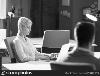 Businesswoman using laptop at work in modern office