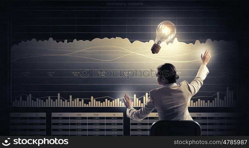 Businesswoman using media panel. Businesswoman sitting in chair and using virtual interface