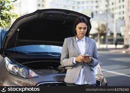 businesswoman using smartphone get help her broken down car