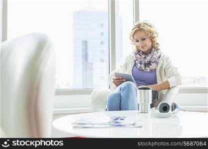 Businesswoman using tablet PC at creative office lobby