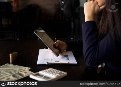 Businesswoman using tablet to the situation on the market value , Business concept.