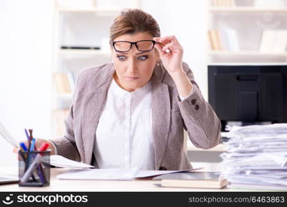 Businesswoman very busy with ongoing paperwork