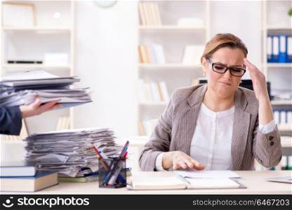 Businesswoman very busy with ongoing paperwork