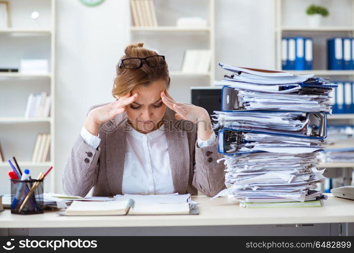 Businesswoman very busy with ongoing paperwork