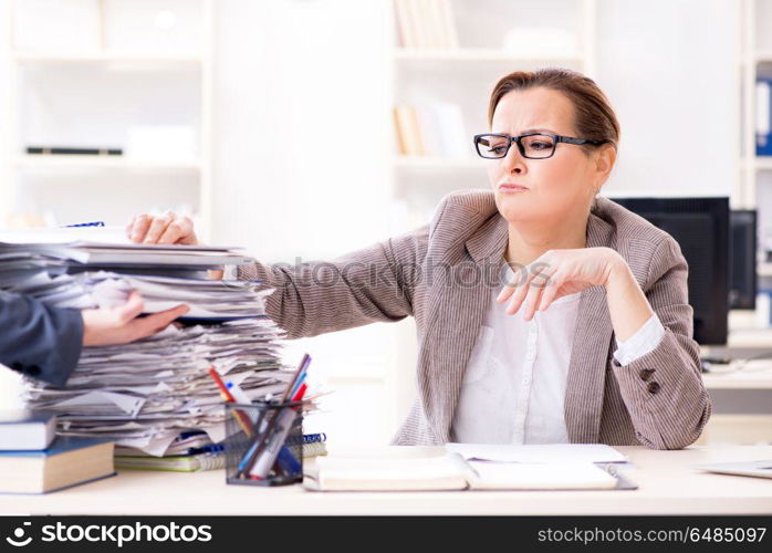 Businesswoman very busy with ongoing paperwork