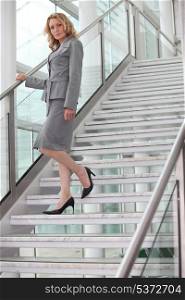 Businesswoman walking down steps