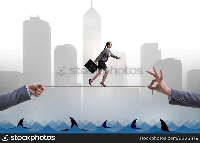 Businesswoman walking on tight rop in business concept