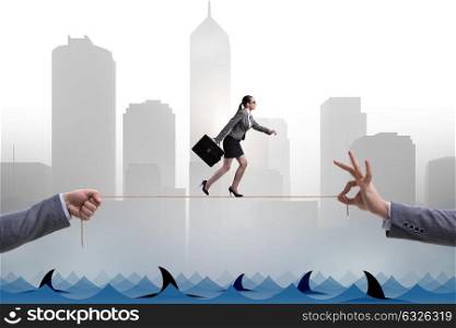 Businesswoman walking on tight rop in business concept