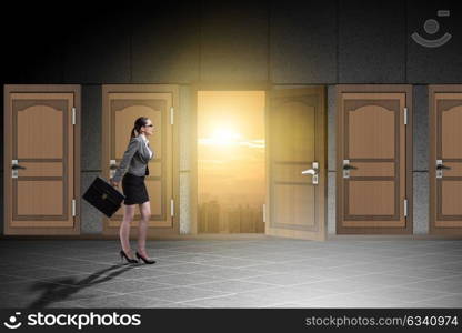 Businesswoman walking towards open door