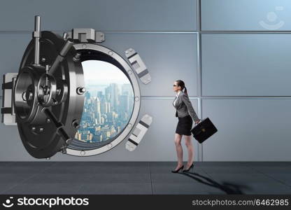 Businesswoman walking towards open vault door