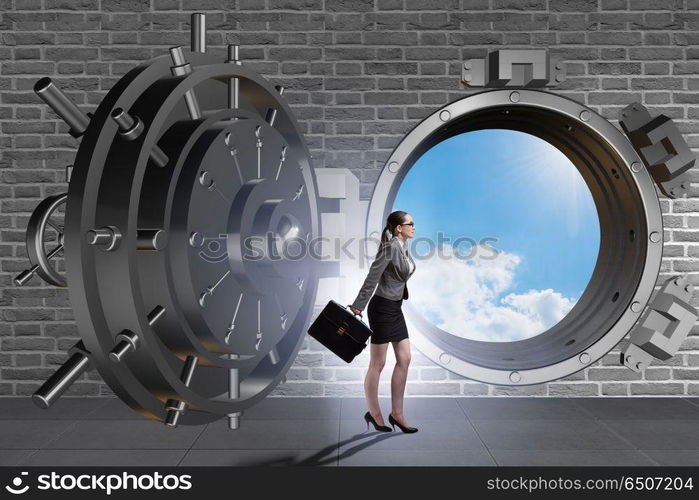 Businesswoman walking towards open vault door