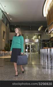 Businesswoman walking with a briefcase at an airport