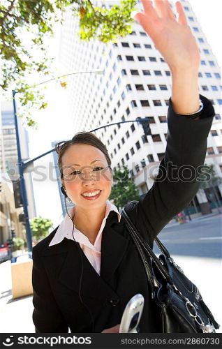Businesswoman waving at street