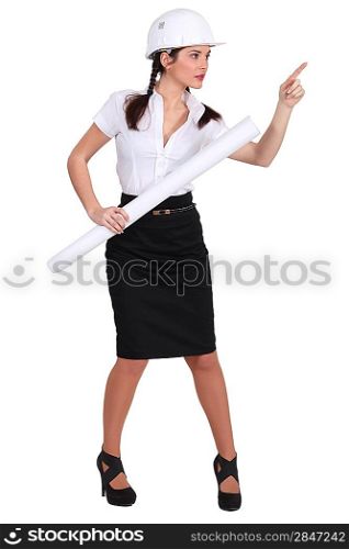 businesswoman wearing a helmet pointing at something