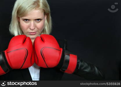 Businesswoman wearing boxing gloves