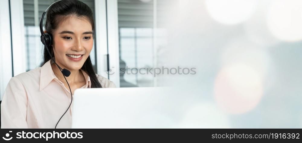 Businesswoman wearing headset working actively in office . Call center, telemarketing, customer support agent provide service on telephone video conference call.. C1