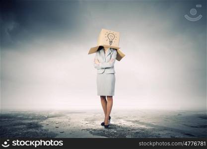 Businesswoman wearing on head carton box with sign. Woman with box on head