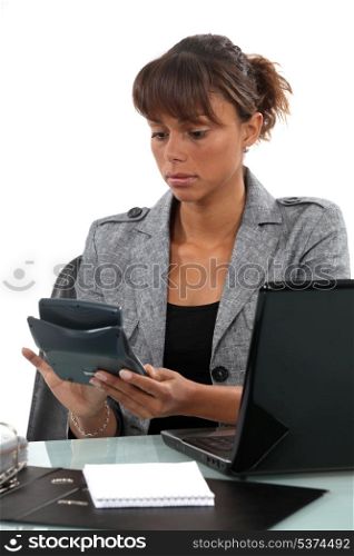 Businesswoman with a calculator