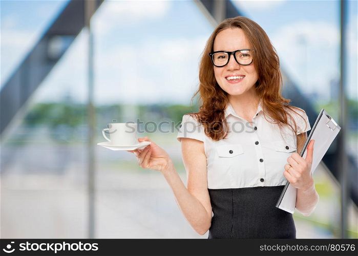 businesswoman with a cup of coffee in the office