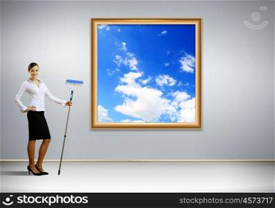 Businesswoman with a paint brush creating natural background