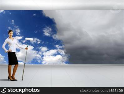 Businesswoman with a paint brush creating natural background