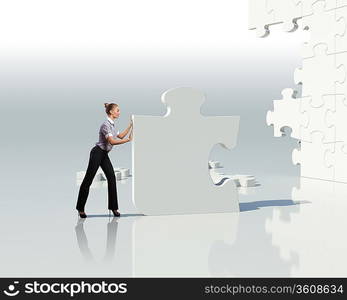 Businesswoman with a puzzle pieces on the background