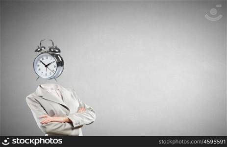 Businesswoman with alarm clock instead of his head