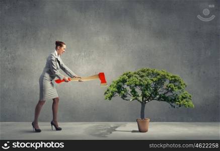 Businesswoman with axe representing problem of deforestation. Stop cutting trees