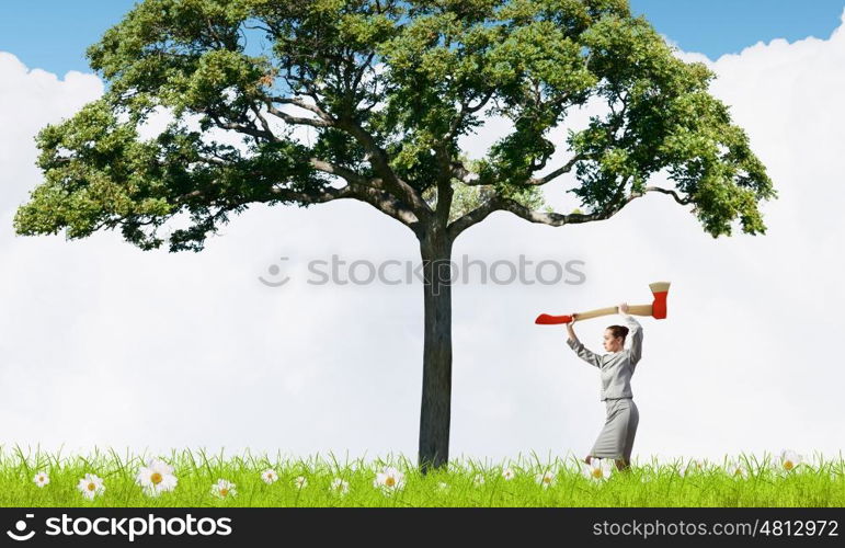 Businesswoman with axe representing problem of deforestation. Stop cutting trees