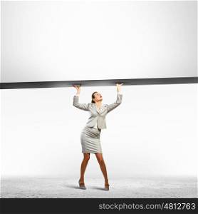 Businesswoman with banner. Businesswoman holding blank banner above head. Place for text