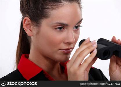 Businesswoman with binoculars