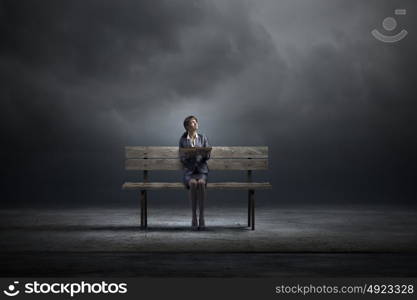 Businesswoman with book. Young smiling businesswoman sitting on bench with book in hands